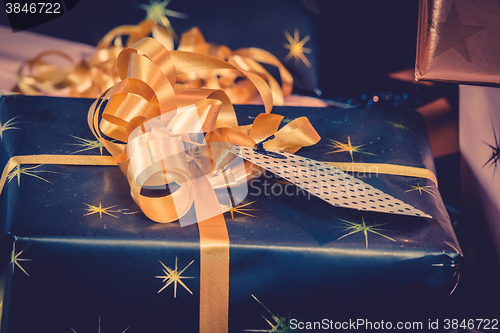 Image of Christmas gifts with golden ribbon