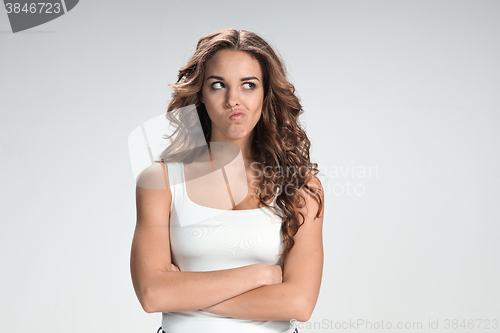 Image of The happy thoughtful woman on gray background