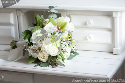 Image of Wedding bouquet with white roses on wooden surface