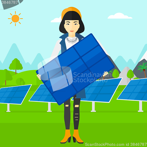 Image of Woman holding solar panel.