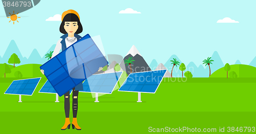 Image of Woman holding solar panel.