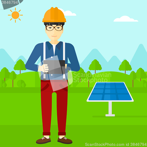 Image of Man holding tablet computer.