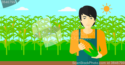 Image of Farmer holding corn.