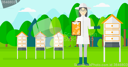 Image of Bee-keeper at apiary.