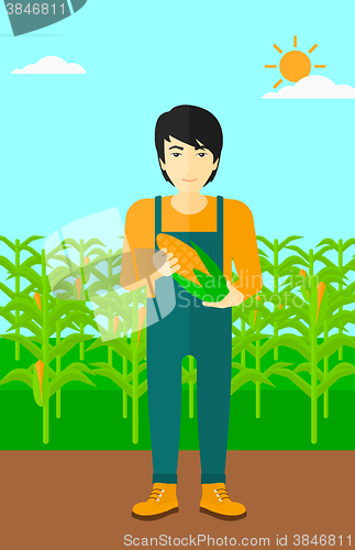 Image of Farmer holding corn.