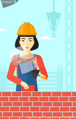 Image of Bricklayer with spatula and brick.