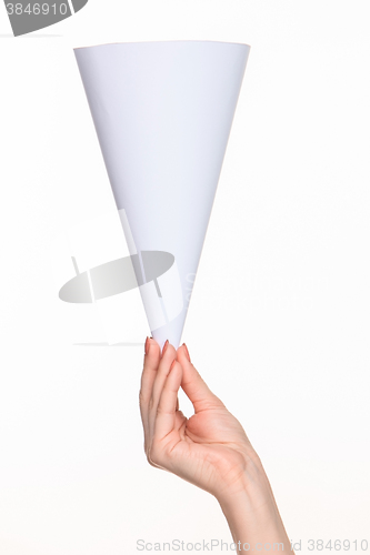 Image of The white cone in the  female hands on white background