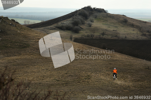 Image of Man cyclist with backpack riding the bicycle