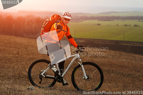 Image of Man cyclist with backpack riding the bicycle