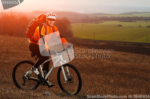 Image of Man cyclist with backpack riding the bicycle