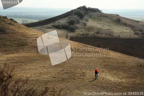 Image of Man cyclist with backpack riding the bicycle