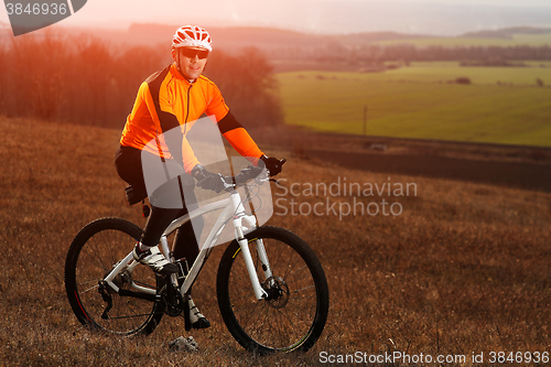 Image of Man cyclist with backpack riding the bicycle