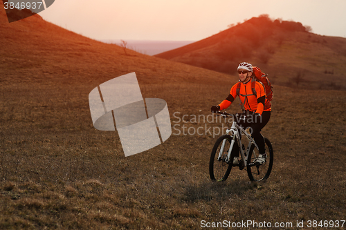 Image of Man cyclist with backpack riding the bicycle