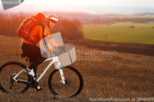 Image of Man cyclist with backpack riding the bicycle