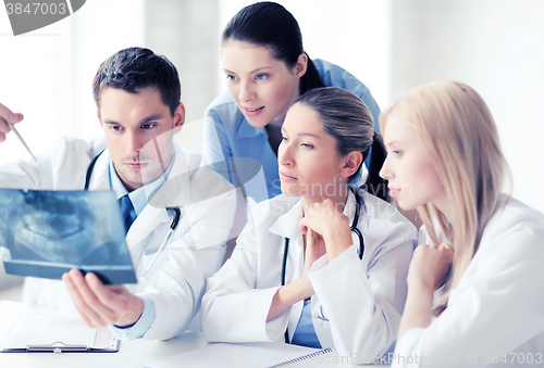 Image of group of doctors looking at x-ray