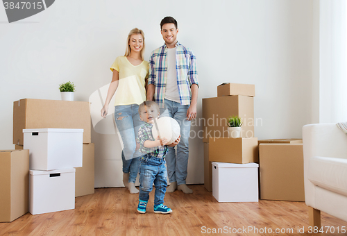 Image of happy family moving to new home and playing ball