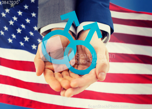 Image of close up of happy male gay couple with love symbol