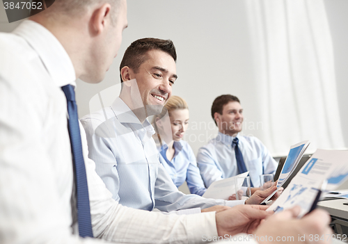 Image of smiling business people meeting in office