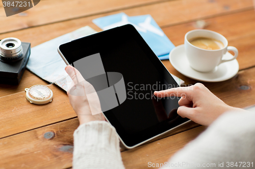 Image of close up of traveler hands with tablet pc and map