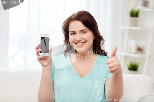 Image of happy plus size woman with smartphone at home
