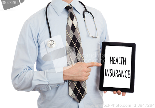 Image of Doctor holding tablet - Health insurance