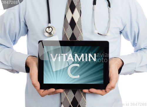 Image of Doctor holding tablet - Vitamin C