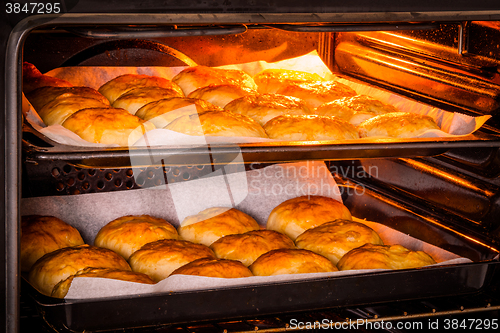 Image of Hot oven with golden buns