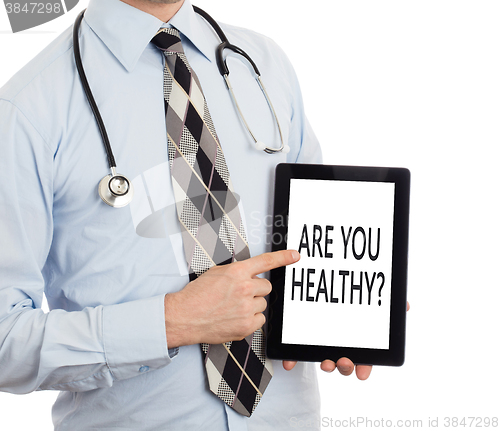 Image of Doctor holding tablet - Are you healthy?