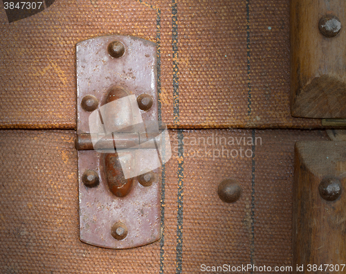 Image of Old canvas trunk hinge close up