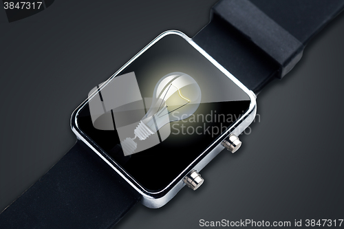 Image of close up of black smart watch with light bulb