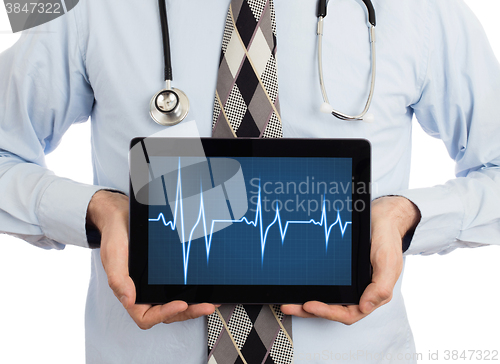 Image of Doctor holding tablet - Heartbeat graph