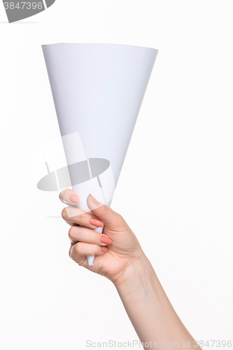 Image of The white cone in the  female hands on white background