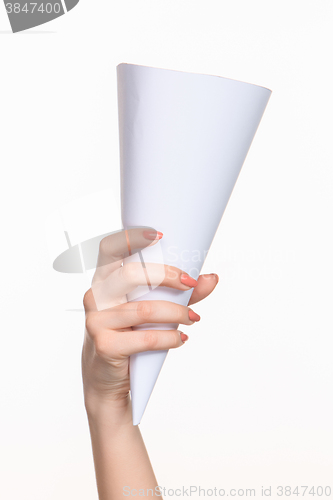 Image of The white cone in the  female hands on white background