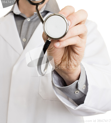 Image of Close up of a Doctor\'s hand, holding a stethoscope 