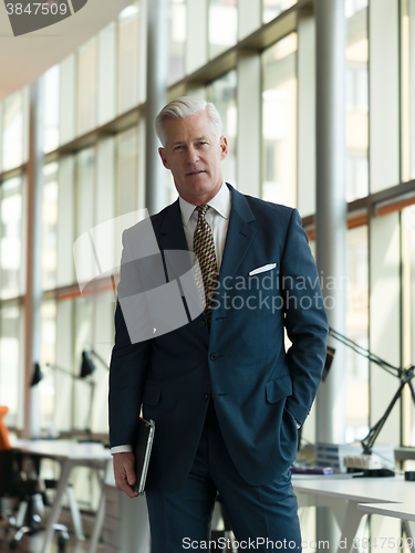 Image of senior business man working on tablet
