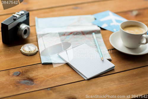Image of close up of notepad with map and travel tickets