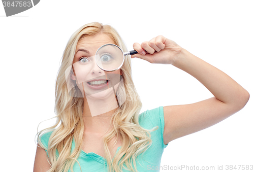 Image of happy young woman with magnifying glass