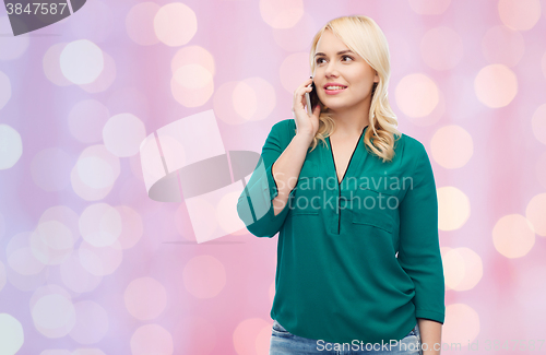Image of happy young woman calling on smartphone