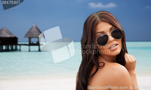 Image of young woman with sunglasses on beach