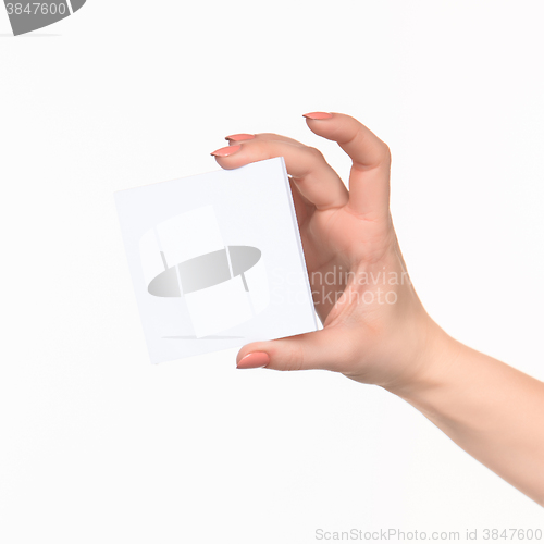 Image of Female hand holding blank paper for records on white.