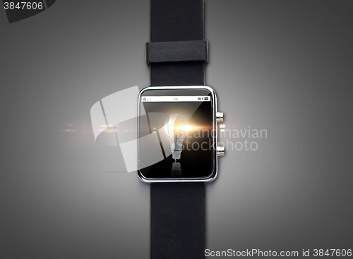 Image of close up of smart watch with light bulb on screen