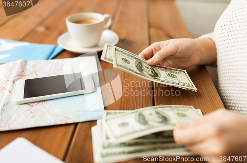 Image of close up of traveler hands counting dollar money
