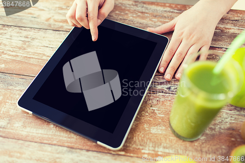 Image of close up of woman hands tablet pc and fruit juice