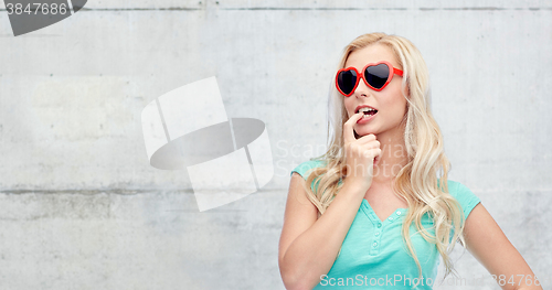 Image of happy young blonde woman or teenager in sunglasses