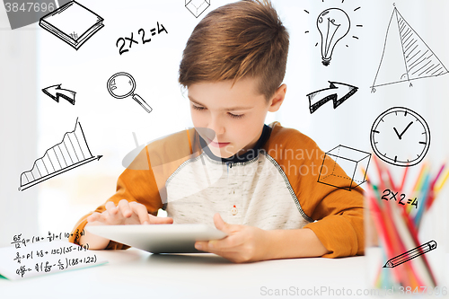 Image of close up of boy with tablet pc computer at home