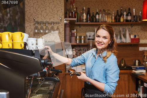 Image of barista woman making coffee by machine at cafe