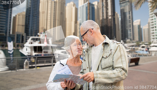 Image of happy senior couple with city map over harbor