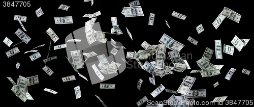 Image of close up of us dollar money flying over black