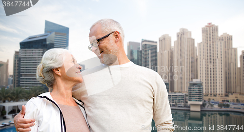 Image of senior couple hugging over dubai city waterfront