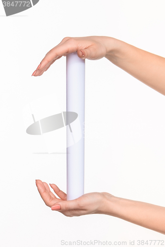 Image of The cylinder female hands on white background